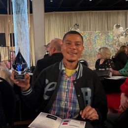 a person holding up an award at a party